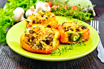 Pepper stuffed with mushrooms and couscous in green plate
