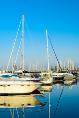 Modern sailboats and luxury yachts parked in the seaport on summ