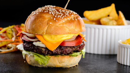 Set with juicy delicious burger with meat, cheese and tomatoes, 