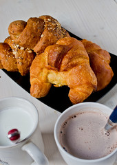 croissants with butter and cereals with a cup of cappuccino