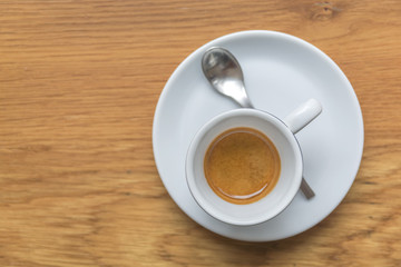 Perfect cup of espresso in white cup on wooden table