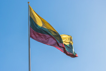 the flag of Lithuania against the blue sky.