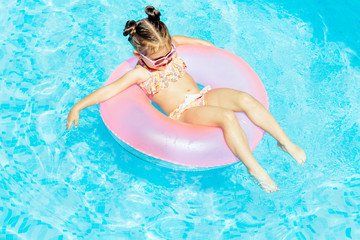 Cute and funny girl in swimming pool