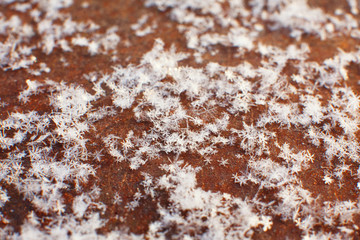 Snowflakes on an old vintage wooden background. Selected focus. Macro. Close-up.