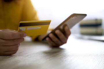 Image of Young woman using smartphone for online shopping website and pay by credit card, Online payment and shopping concept