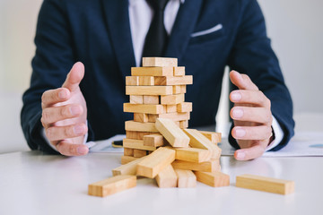 Alternative risk concept, plan and strategy in business protect with balance wooden stack with hand...