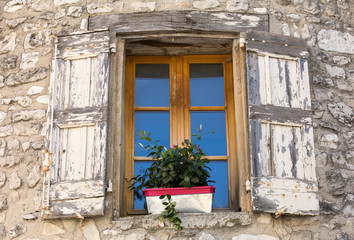 Fototapeta na wymiar Old stone house with wooden shutters, Provence, France.