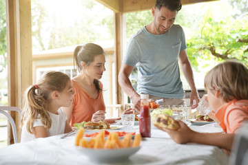 Family on vacation having outdoor lunch