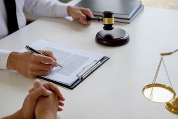 Judge gavel with Justice lawyers having team meeting at law firm in background. Concepts of law.