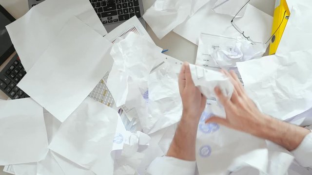 Accountant wakes up at work and looking for important document.
