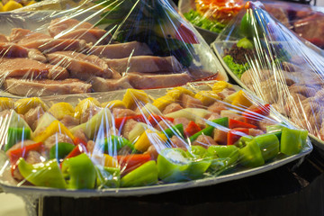 Raw meat in plastic wraps.Many buffet ready for service.
