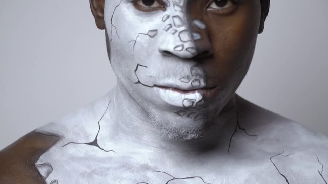 Body painting on a guy in the form of broken porcelain
