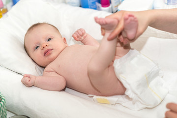 Portrait of baby during diapers change