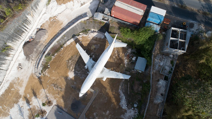 Aerial top drone view of abandoned airplane, old crashed aircraft wreck tourist attraction located...