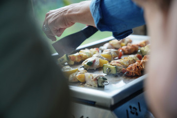 Closeup of chicken skewers cooking on grill
