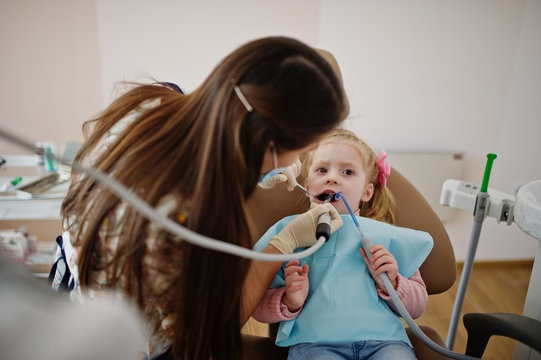Little baby girl at dentist chair. Children dental.