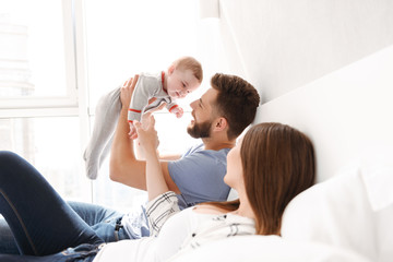 Couple parents having fun with their little child son.