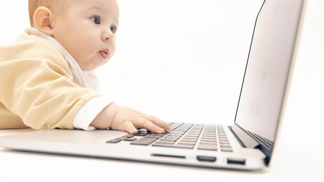 Cute baby working on a laptop