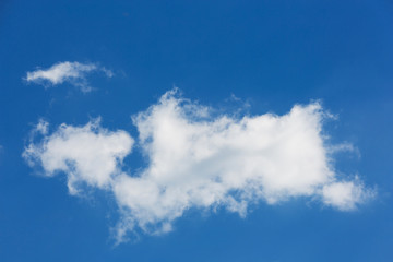 a large white cloud of interesting bizarre shape, on a blue sky, natural background