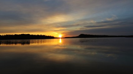 Fototapeta na wymiar Sunset Over Beautiful Lake with Cloudy Sky in background