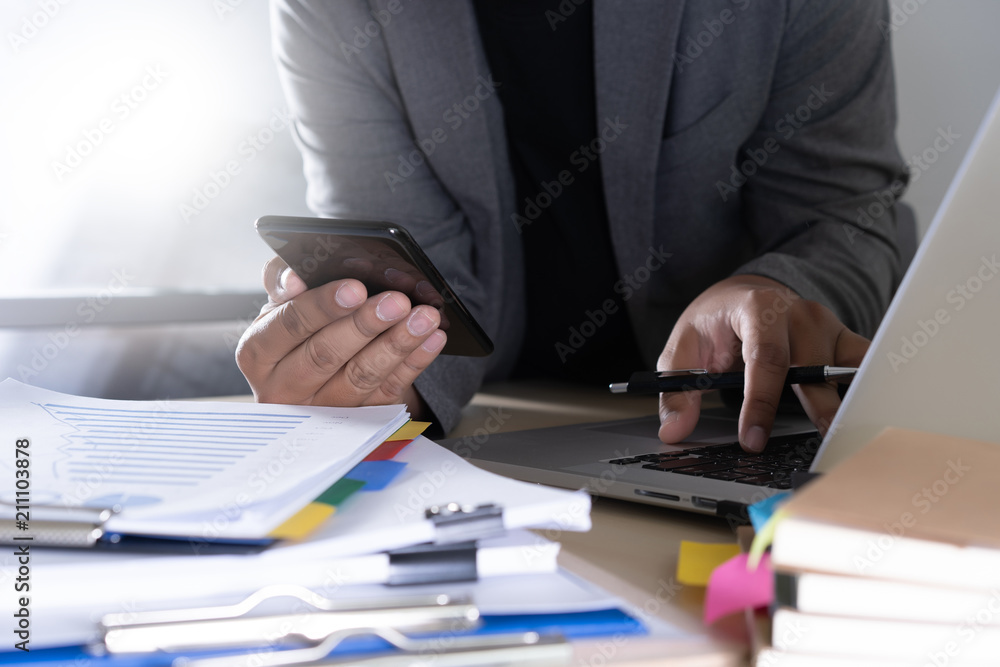 Poster businessman using phone smart phone and notebook computer