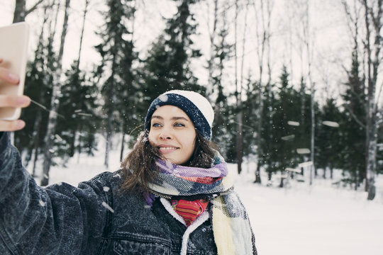 Young woman taking selfie in winter setting
