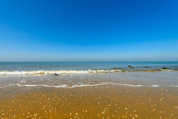 Soft wave of the blue sea on the sand beach