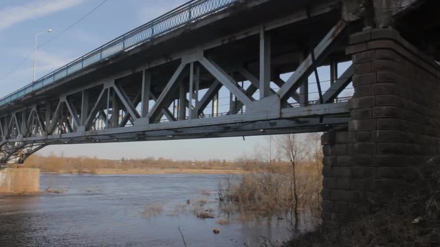 Old ruined bridge across the river in emergency condition