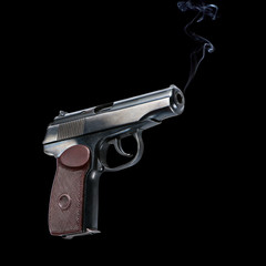 automatic military pistol on black background