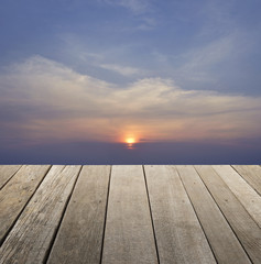 Fototapeta na wymiar Empty old wood floor with sunset sky with clouds for background, for your product display montage
