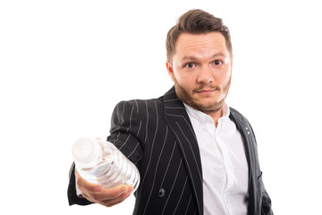 Portrait of business man offering a bottle of water.