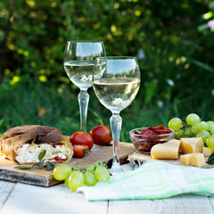 Fototapeta premium White wine and light snacks, Grapes, wine, cheese, pie.