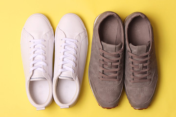 male sneakers and sneakers on a colored background top view. men's footwear. minimalism