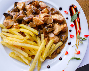 Meat and fries meal served on table of restaurant