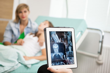 Fototapeta na wymiar Doctor reading the xray result on his tablet pc in hospital 