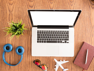 traveler businessman concept image on wooden desk, sunglasses ,book , pot of grass 
