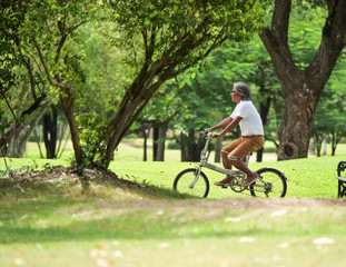 Senior man cyling in Park.Health care concept.