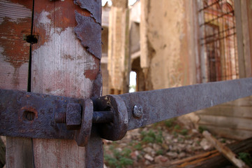 Remains of metal constipation on the destroyed church door