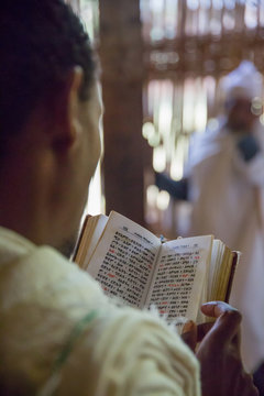 Parishioner reading prayer book
