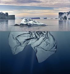 iceberg of garbage plastic floating in ocean with greenland background.