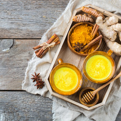 Traditional indian drink turmeric curcuma golden milk with ingredients