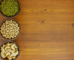 Obraz na płótnie Canvas Flat lay,top view assorted beans included cashews green beans and soybeans on wooden table with copy space