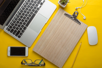 Mock up smartphone and office accessories on colorful background with copy space.view from above