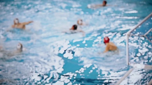 Unfocused video of a water polo match 