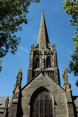 Church spire framed by trees and leaves