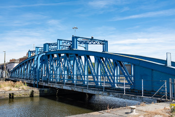 Blue bridge over water at dockyard