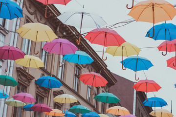 Fototapeta na wymiar many diffrent colours umbrellas street