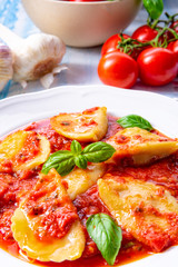 Delicious pasta - ravioli in tomato sauce with basil