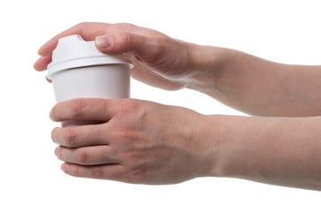 Women's hands open lid of disposable Cup for hot drinks, isolated on white