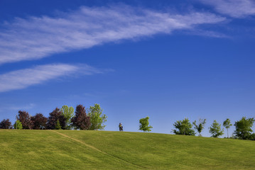 bicycle rider on the top of the hill in the park